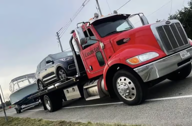 there is a red truck with a boat on the back of it