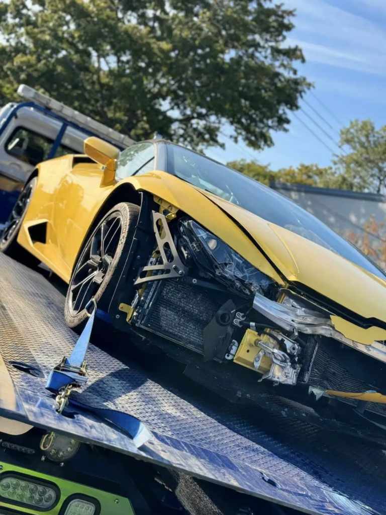 a yellow car is on the back of a flatbed tow truck