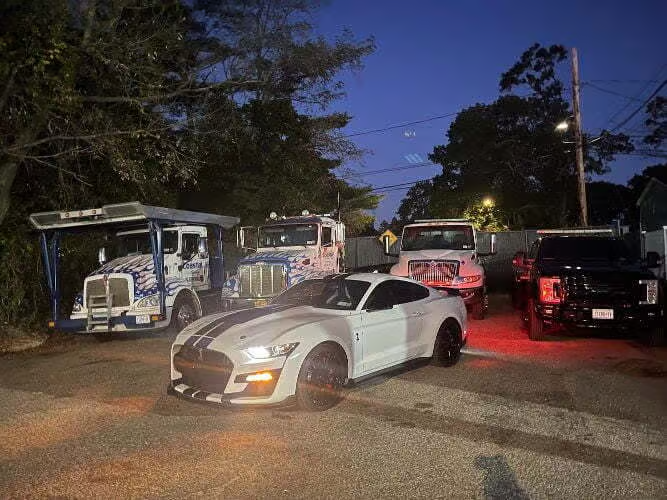 there are many trucks parked in a parking lot at night