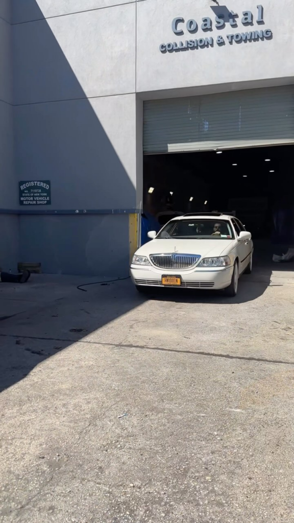 there is a white car parked in front of a building