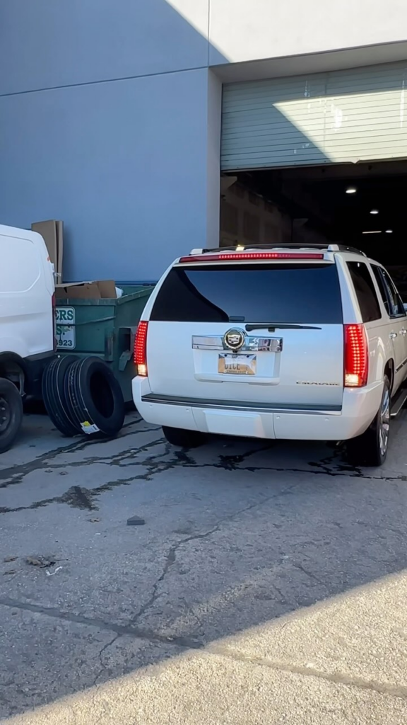 there is a white van parked in front of a building