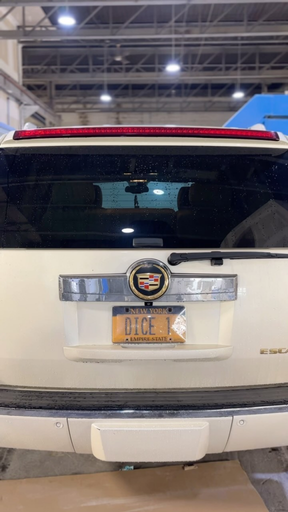 a close up of a white car with a license plate on it