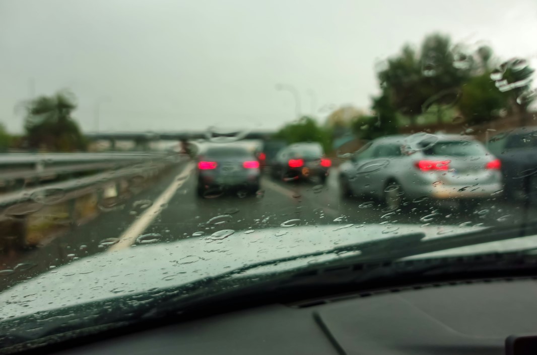 cars driving on a highway in the rain on a rainy day