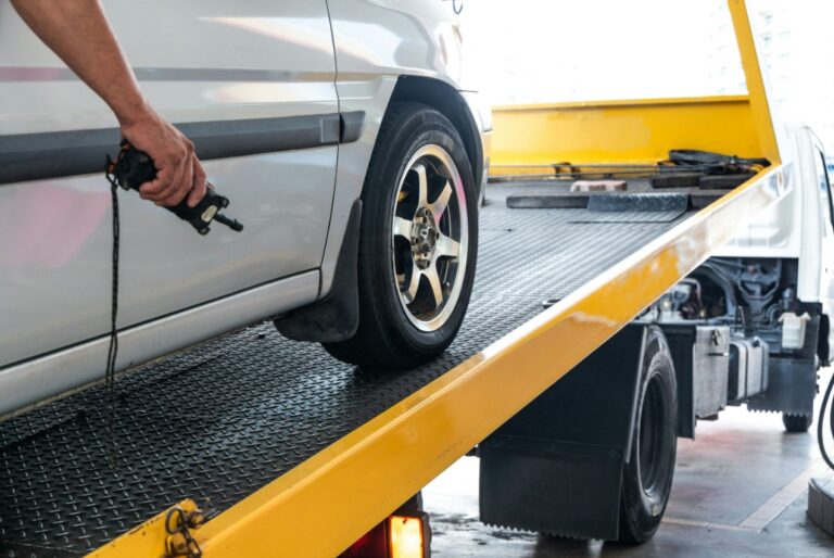 arafed tow truck with a flat bed and flat tire